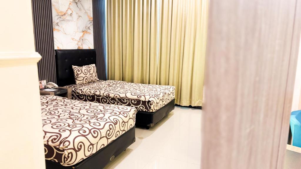 Voodi või voodid majutusasutuse UTC Hotel Semarang toas