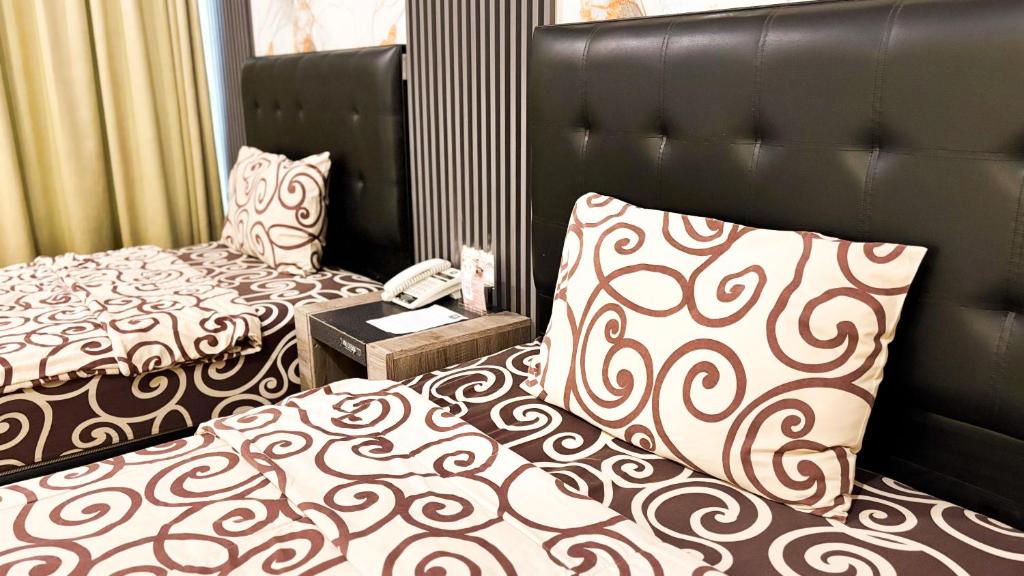 Voodi või voodid majutusasutuse UTC Hotel Semarang toas