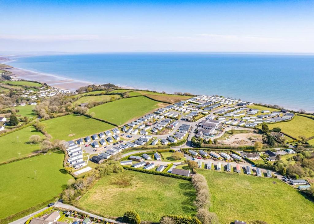an aerial view of a resort near the ocean at Meadow House Holiday Park in Amroth