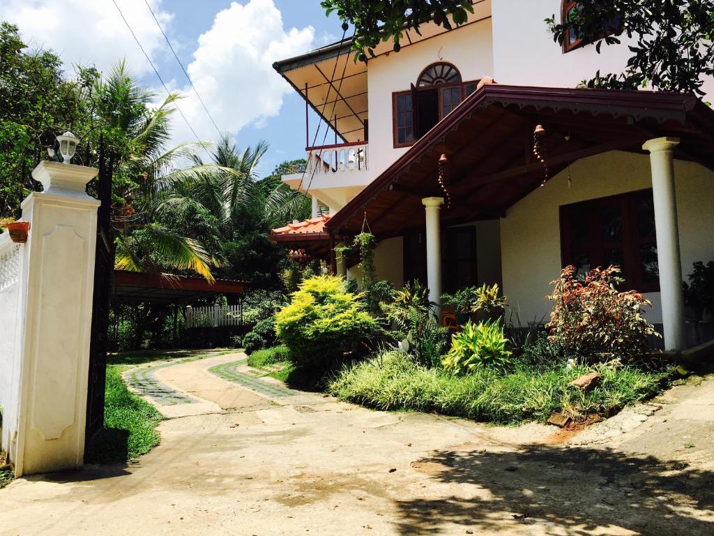 a house with a pathway leading to a building at Hanthana Jungle View Holiday Home in Kandy