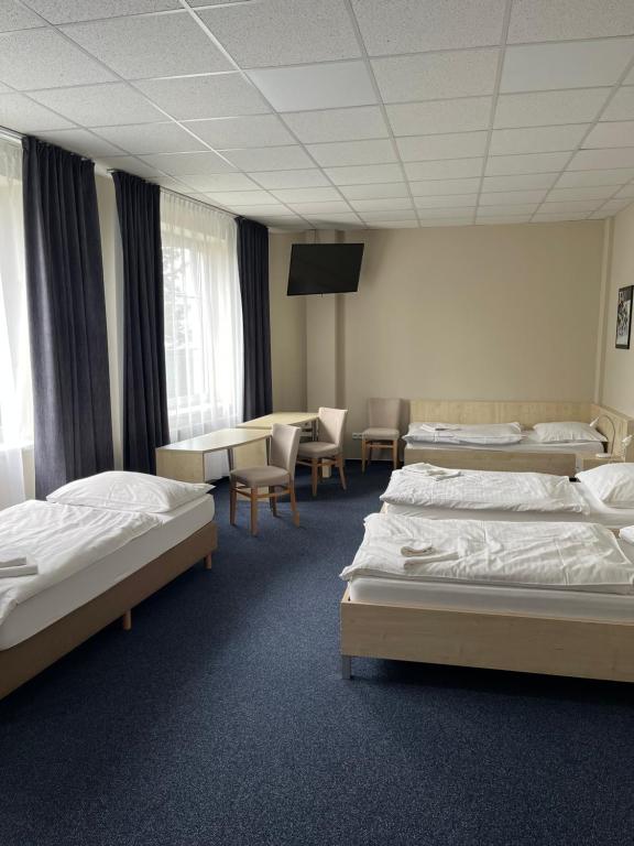 Postel nebo postele na pokoji v ubytování Buly Aréna