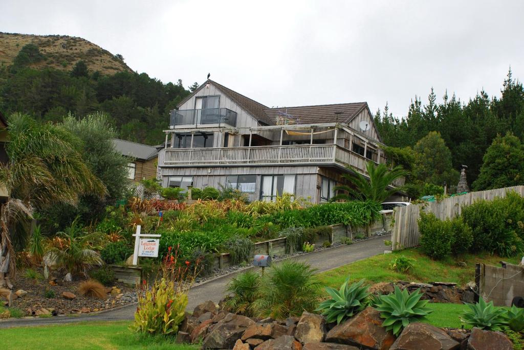 a large house with a garden in front of it at Leighton Lodge in Opito Bay
