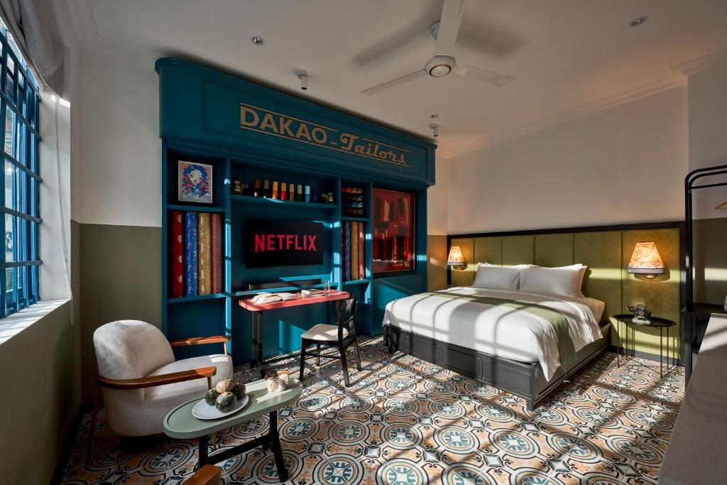 a hotel room with a bed and a book shelf at Dakao Vibe Studios by CIRCADIAN in Ho Chi Minh City