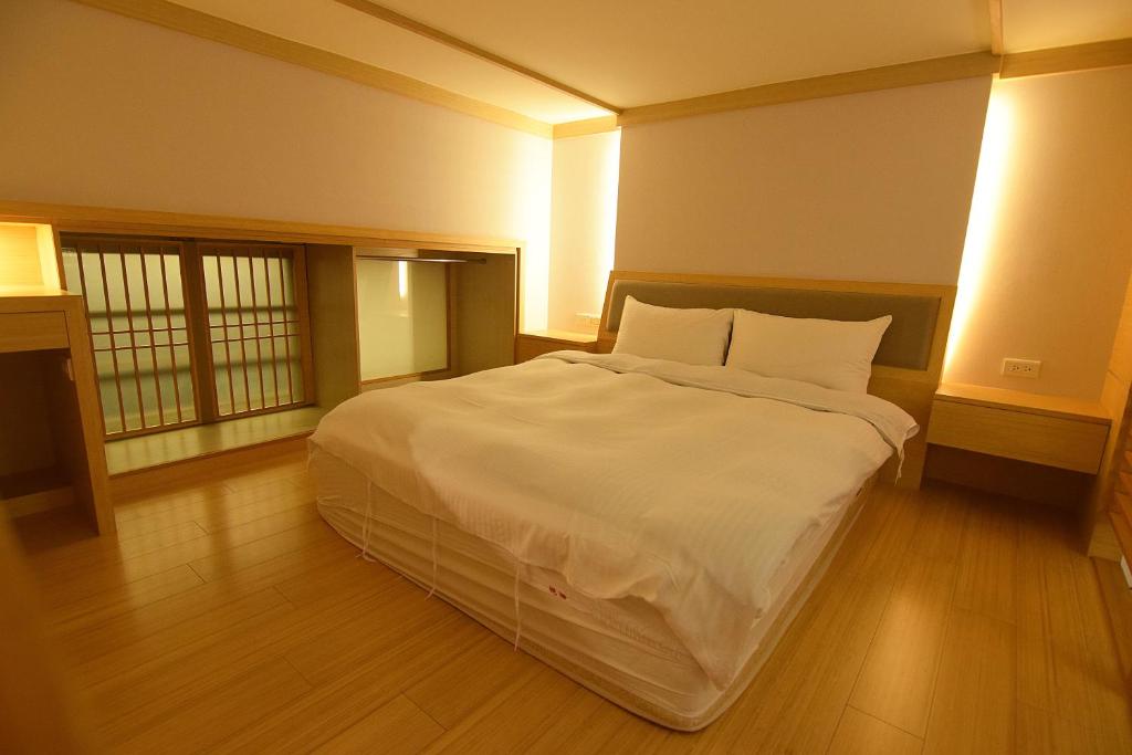 Postel nebo postele na pokoji v ubytování No. 21 Jiaoxi Hot Spring Homestay