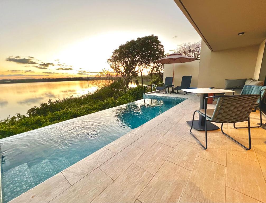 a swimming pool with a view of a river at the 478 -pool & spa- Miyakojima Luxury Villa in Miyako Island