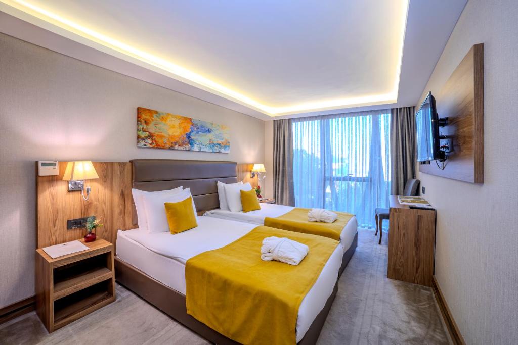 Postel nebo postele na pokoji v ubytování Royal Termal Hotel