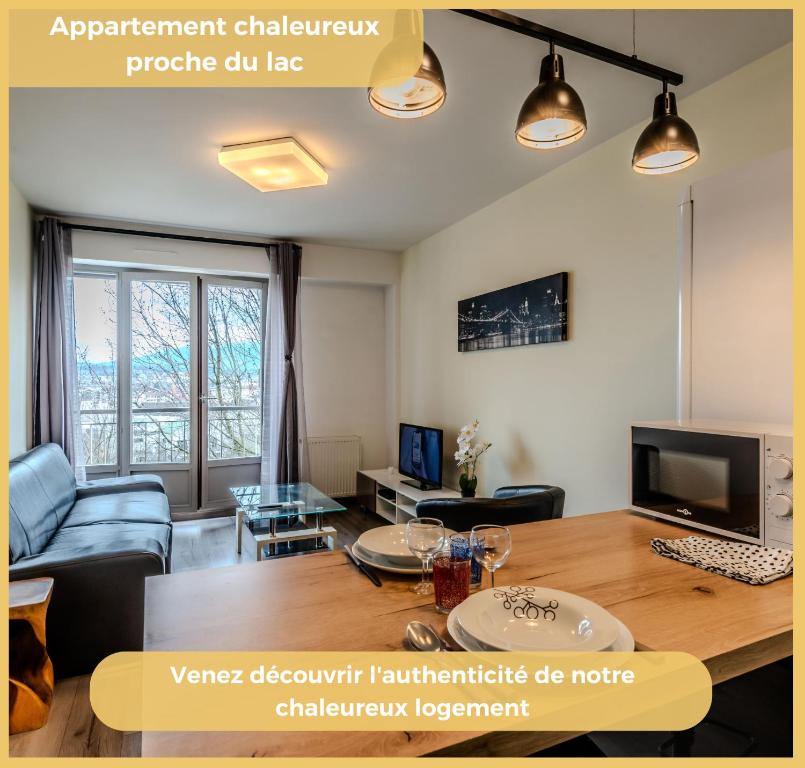 a living room with a table and a tv at Chez Dams I T2 I Annecy in Annecy