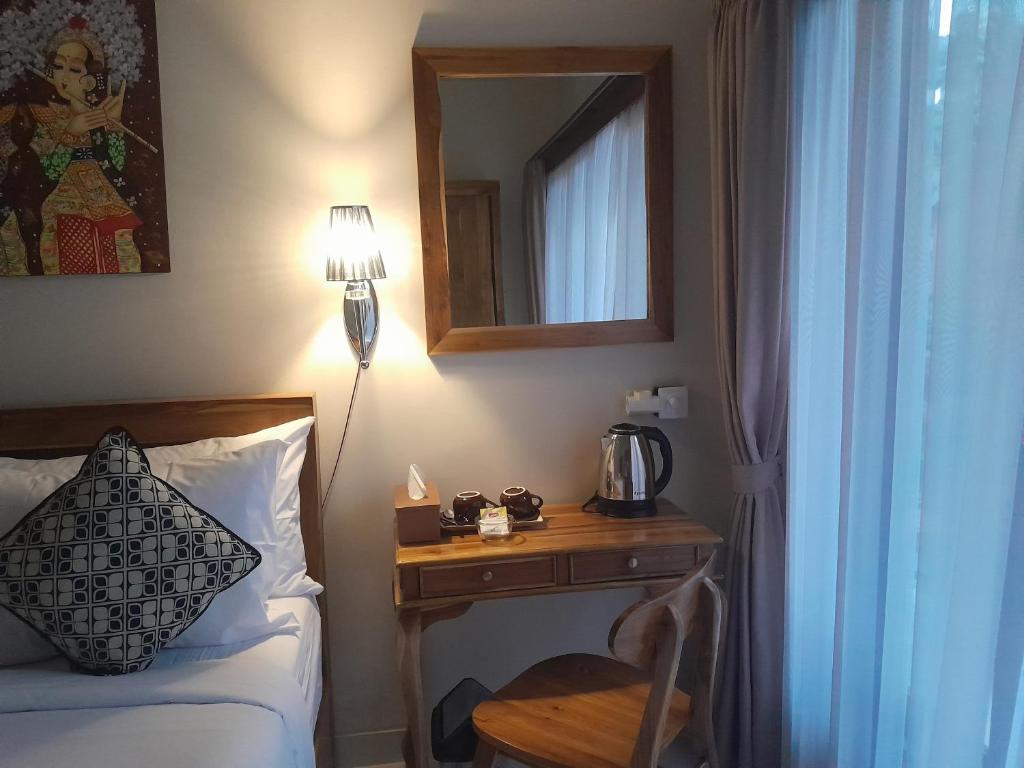 Postel nebo postele na pokoji v ubytování Tirta Sari House