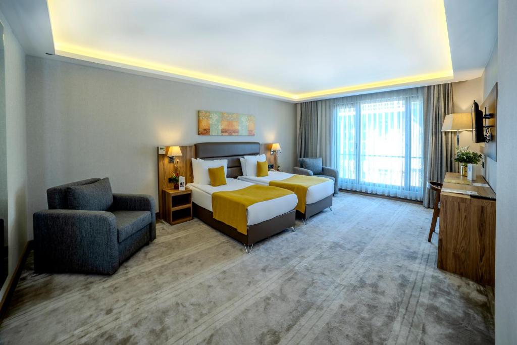 Postel nebo postele na pokoji v ubytování Royal Termal Hotel