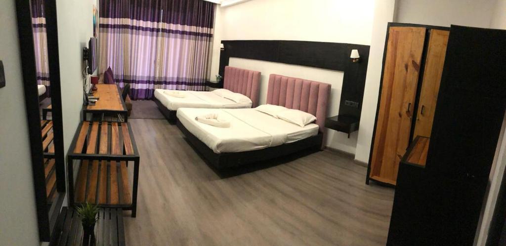 Postel nebo postele na pokoji v ubytování Aura Residence