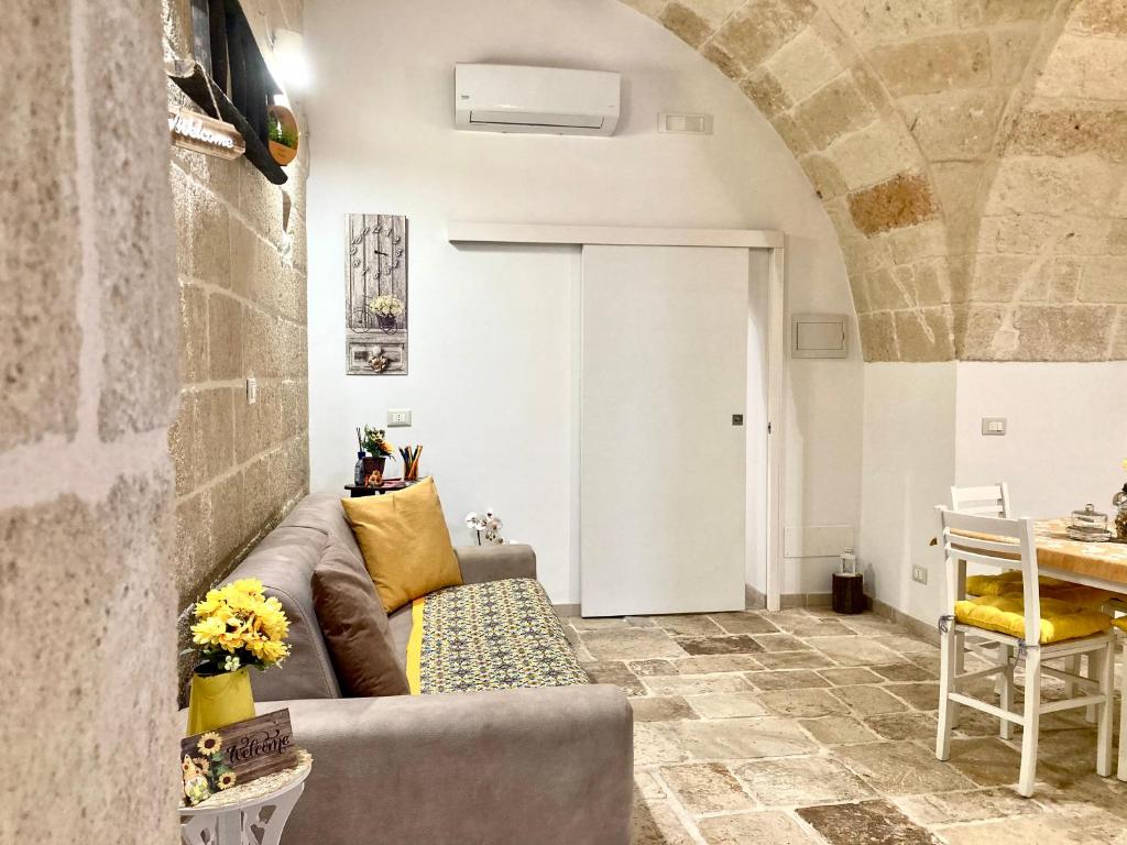 a living room with a couch and a table at Antica Pietra in Polignano a Mare