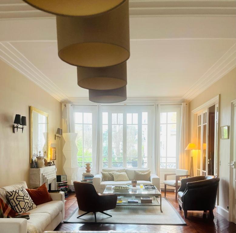 a living room with a couch and a table at House facing Roland Garros stadium - 5 bedrooms in Boulogne-Billancourt