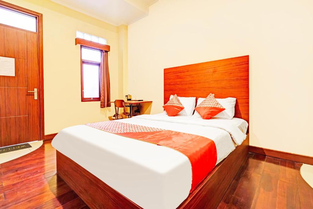 a bedroom with a large bed with a wooden headboard at Dancenter Pasteur Near Near Paris Van Java Mall in Bandung
