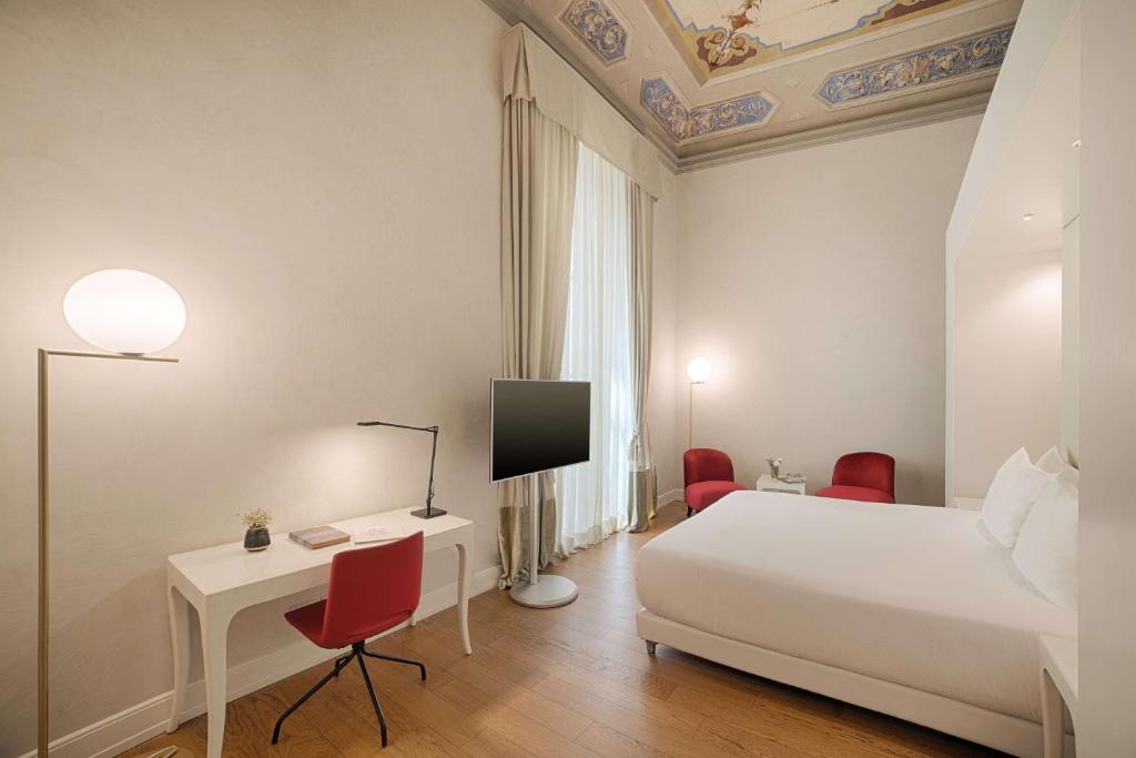 Postel nebo postele na pokoji v ubytování NH Collection Firenze Porta Rossa