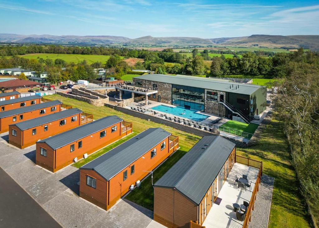 an aerial view of a building with a pool at Wild Rose Holiday Park in Colby