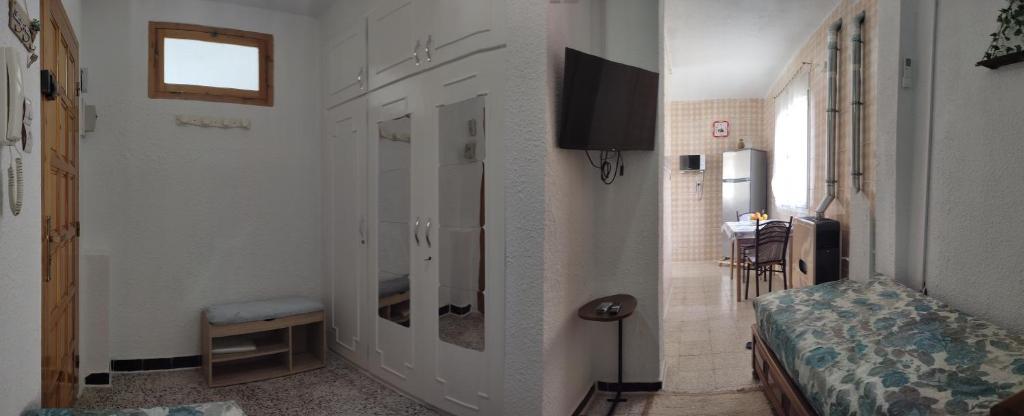 a room with a bedroom with a bed and a bathroom at El Hartoune S in Tlemcen