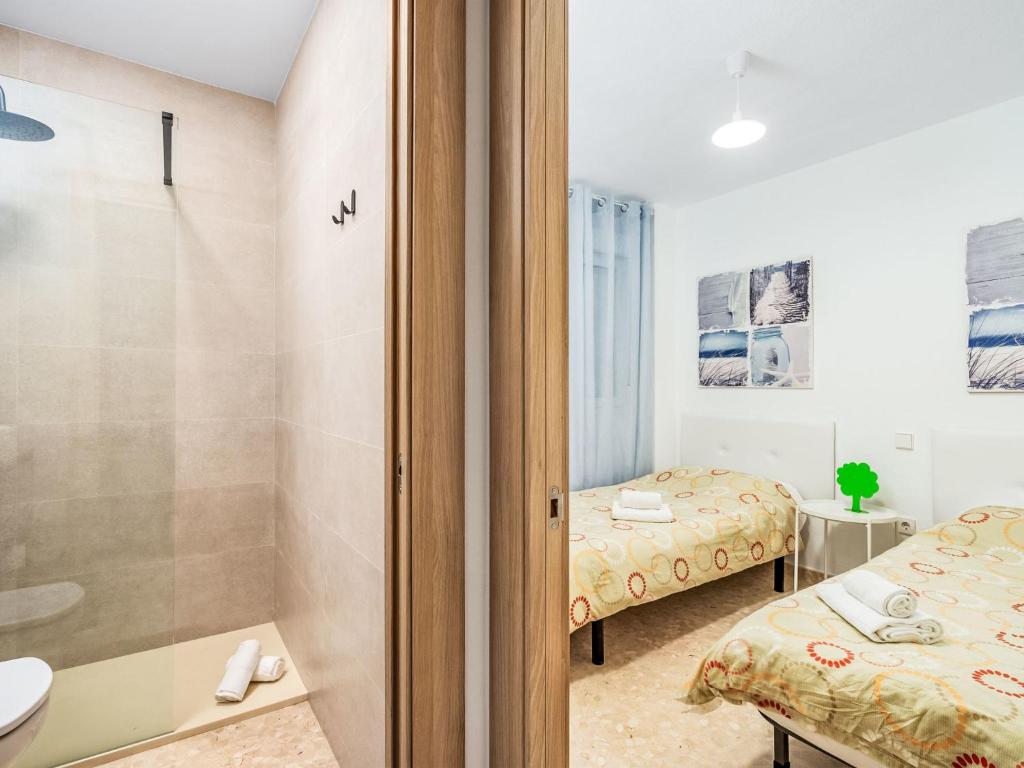 A bed or beds in a room at Apartment Carihuela Playa-2 by Interhome