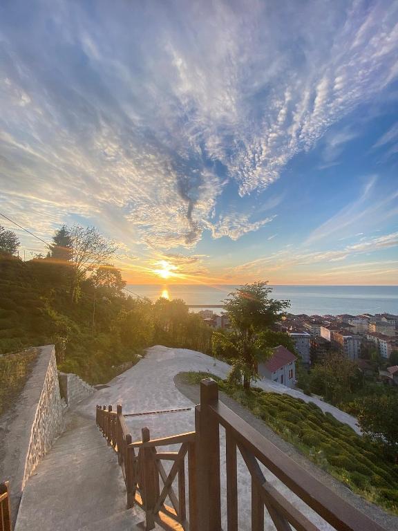 a view of a road with the sunset in the background at Loya Butik Otel Bungalov in Rize