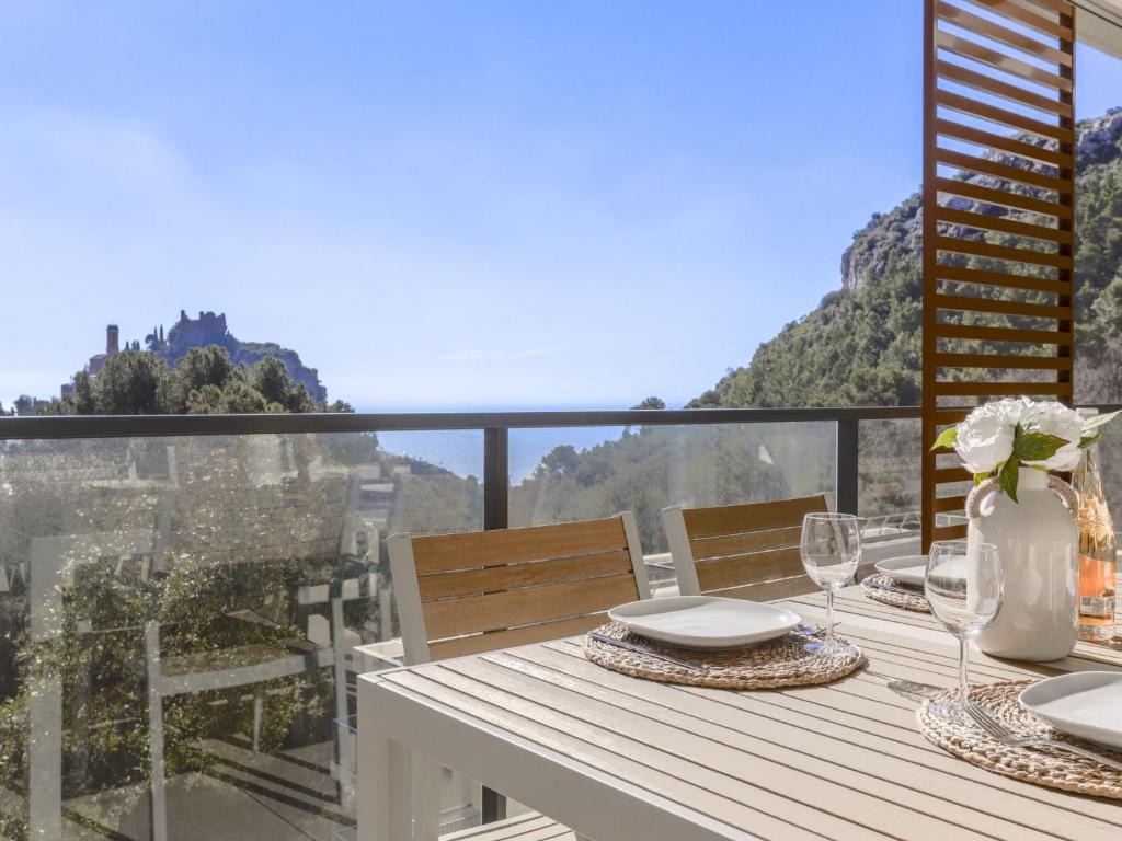 a dining table with a view of the mountains at Apartment Prestige view by Interhome in Èze