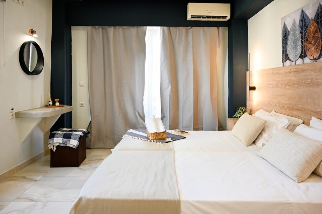 a bedroom with two beds and a window at Cozy Studio #7 in Malia