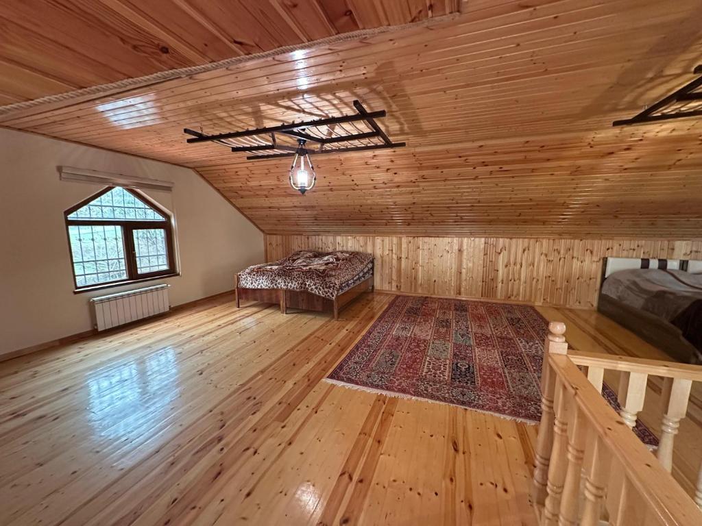 a large room with a bed and a couch in it at Gabala Riverside House in Gabala