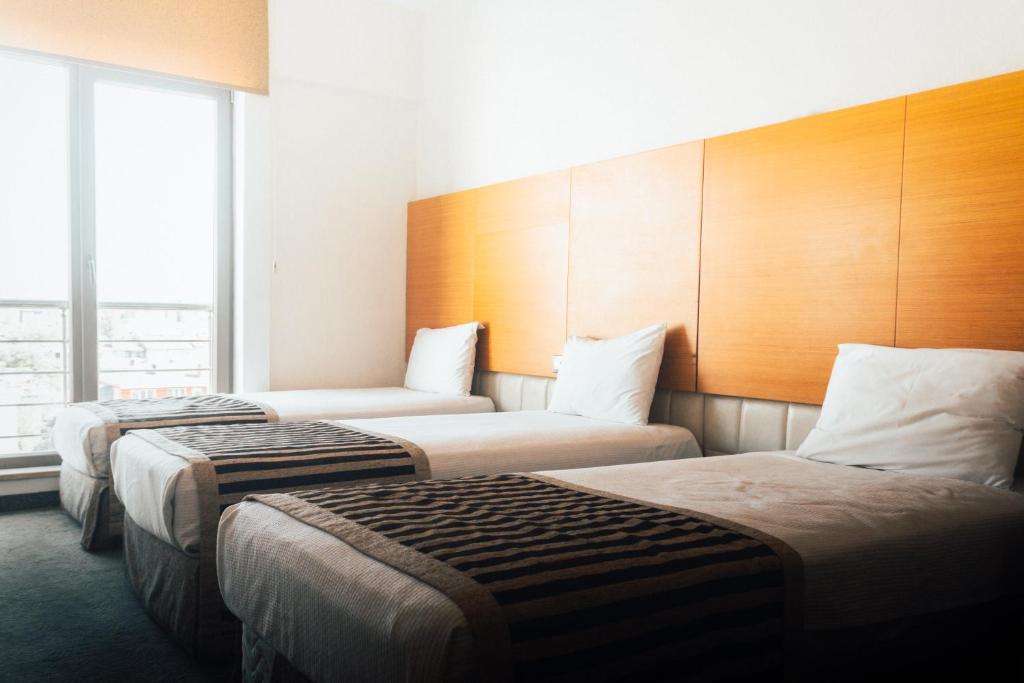 Postel nebo postele na pokoji v ubytování Nüzhet Hotel