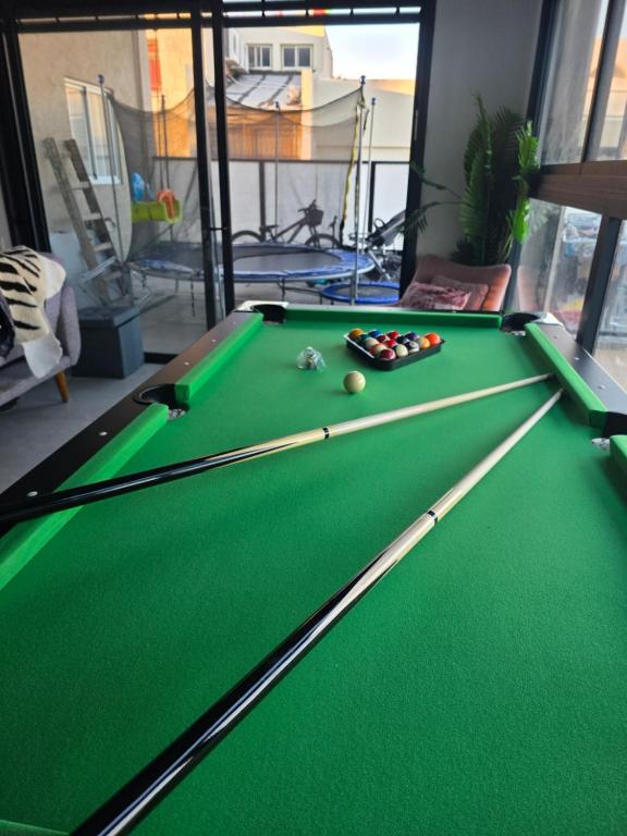 a green snooker table in a room with a pool at פנטאהוז 7 חדרים עם בריכה ונוף מטריף בטבריה קרית שמואל in Tiberias