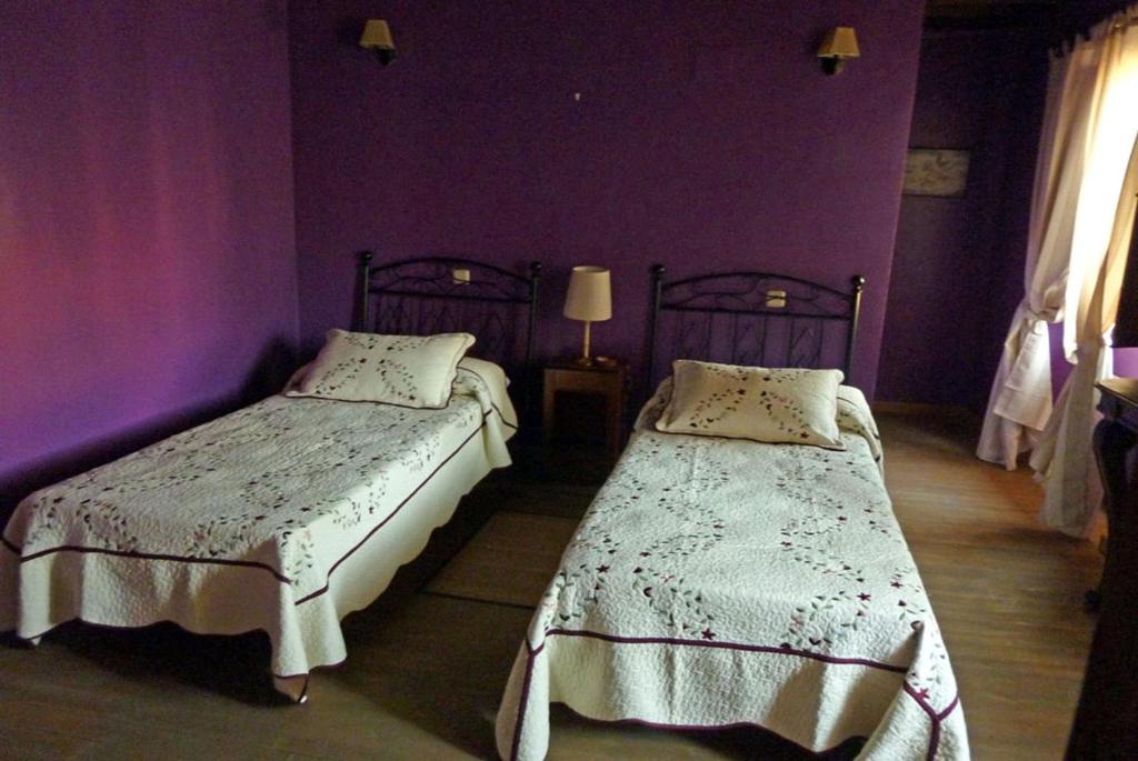 A bed or beds in a room at Posada Villa Maria