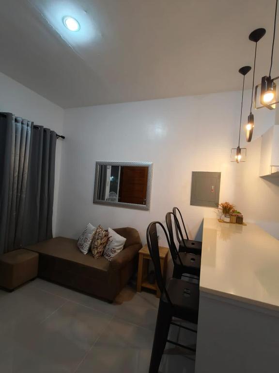 a living room with a couch and a table at Rapha's Place Joy - A in Bacolod