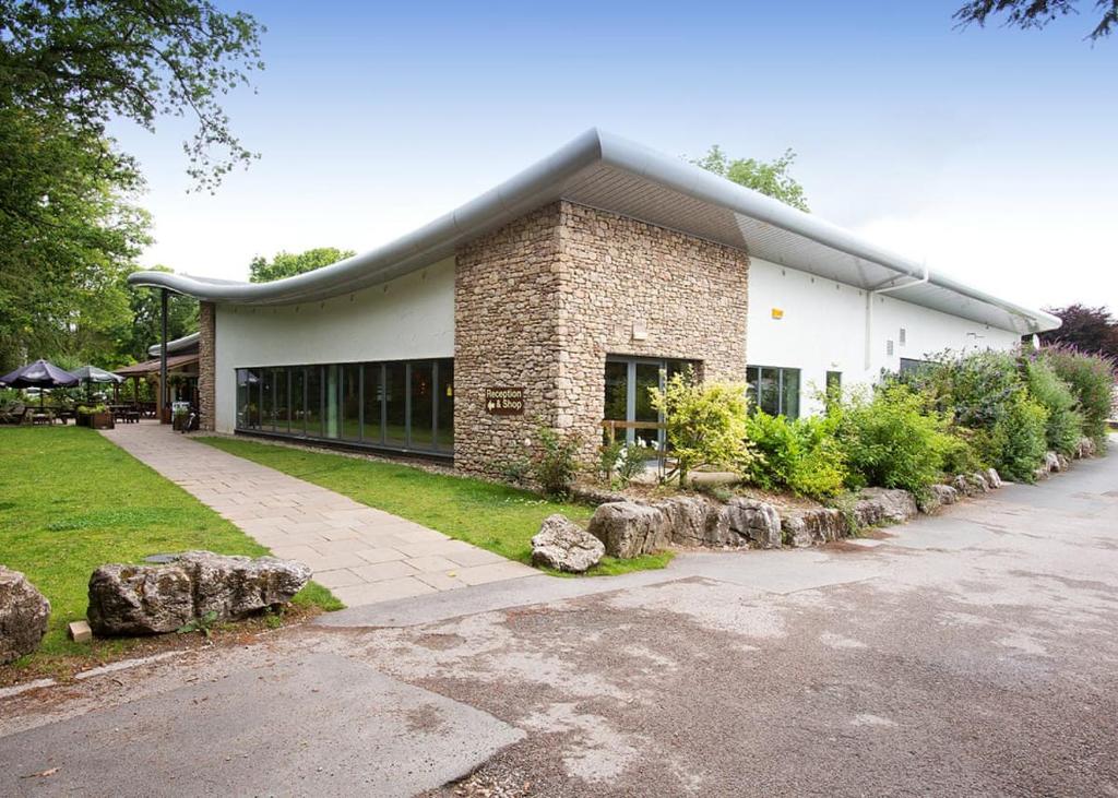 a large brick building with rocks in front of it at Fell End in Milnthorpe