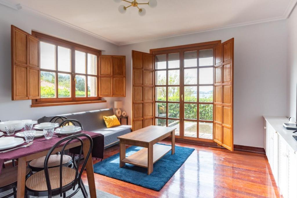 a living room with a couch and a table at Piso en Pedreña - 32001 in Pedreña