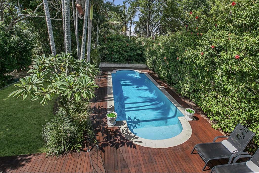 a small swimming pool on a wooden deck at Family Friendly, Pool, 9km to City by Custom Bnb Hosting in Brisbane