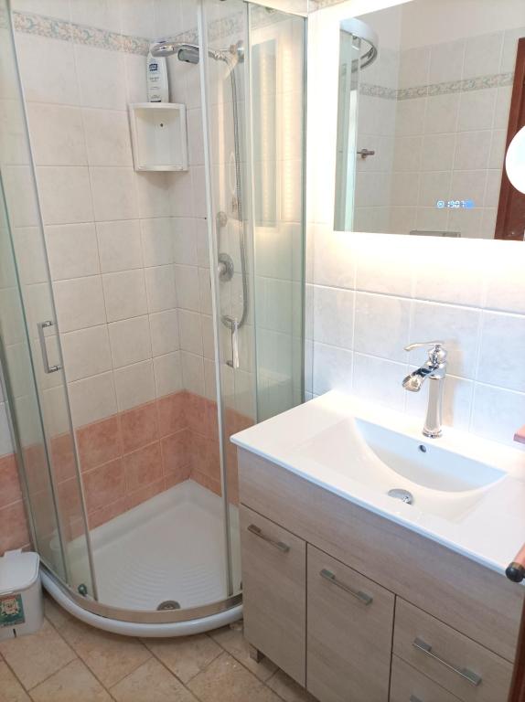 a bathroom with a shower and a sink at Sardinia Yellow House in Solanas