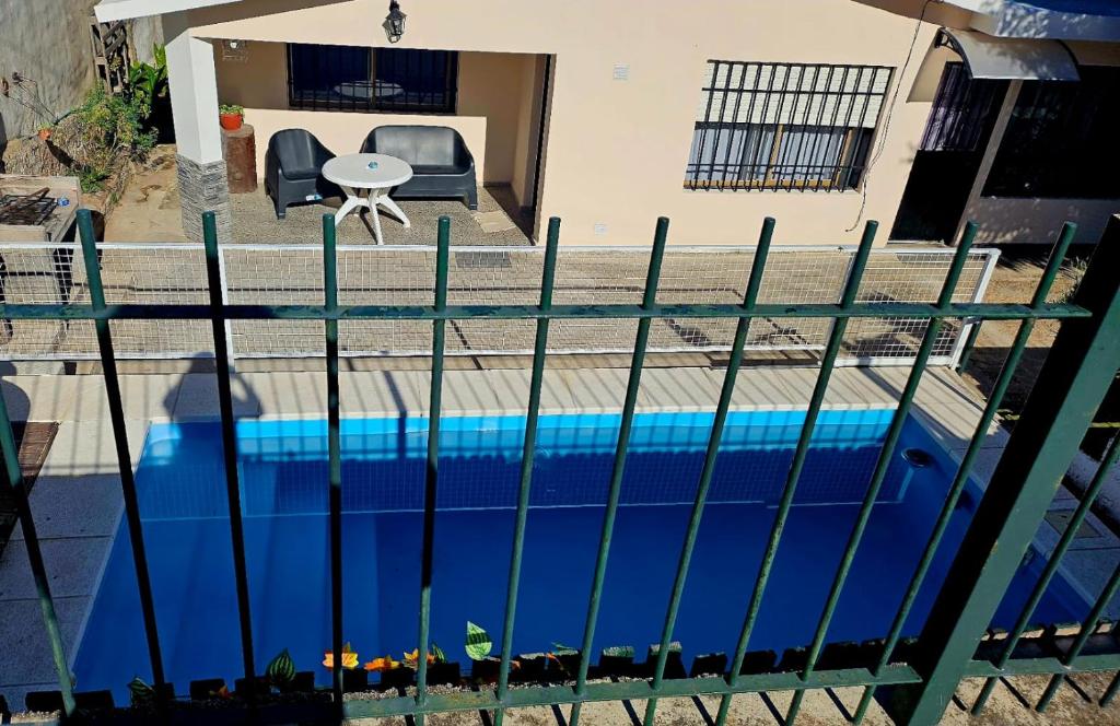 a view of a swimming pool through a fence at LUSANYUN in Villa Carlos Paz