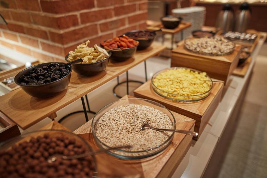 a buffet filled with different types of food on wooden boards at Hotel Convent - Hotel & Resort Adria Ankaran in Ankaran