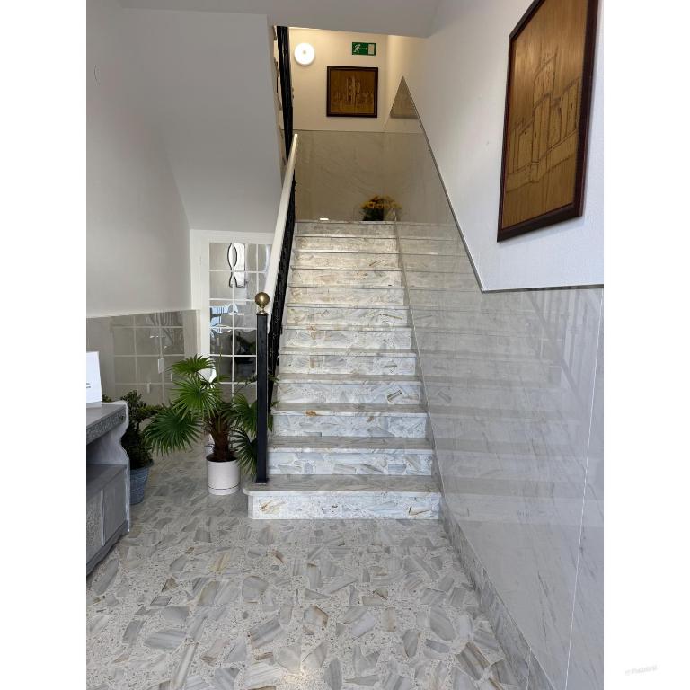 a staircase in a house with stone tiles at Pensión O Castelo in Palas de Rei