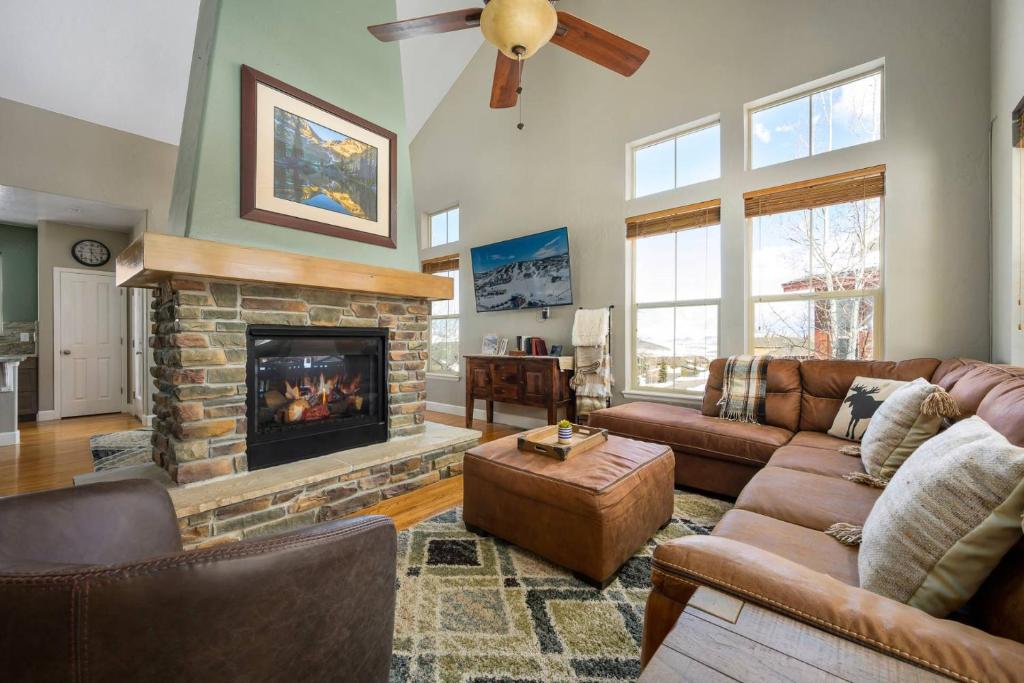 a living room with a couch and a fireplace at Timber Court in Granby