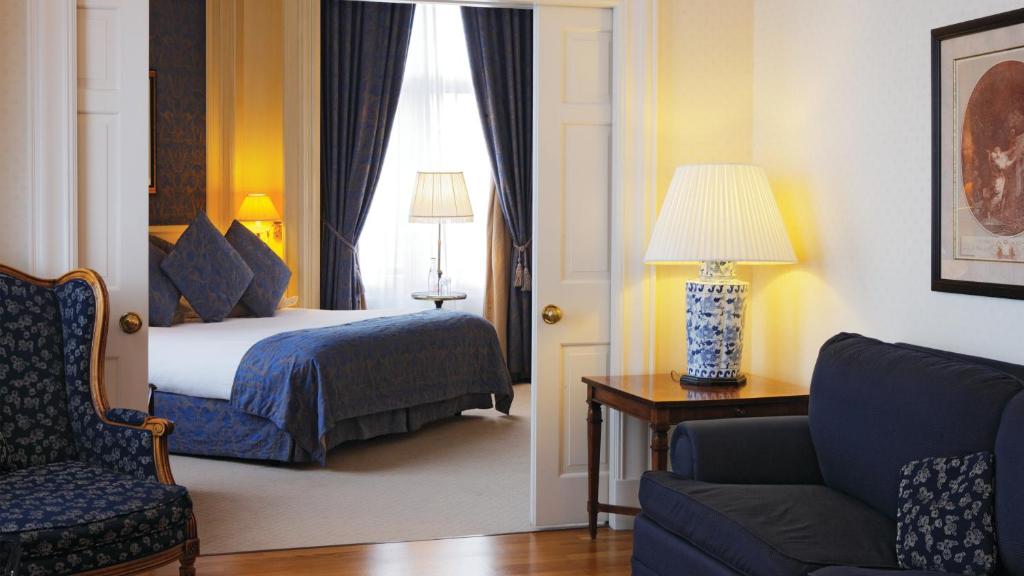 a hotel room with a bed and a chair and a couch at InterContinental Amstel Amsterdam by IHG in Amsterdam