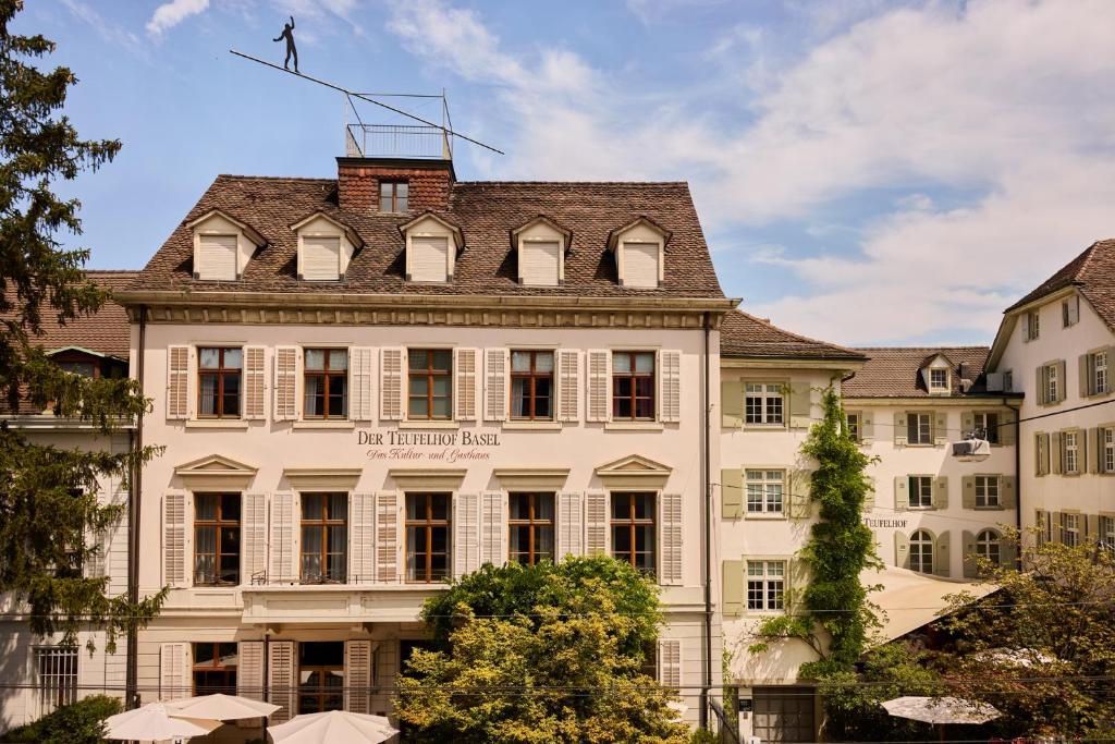 a man standing on the roof of a building at Gast - und Kulturhaus Der Teufelhof Basel in Basel