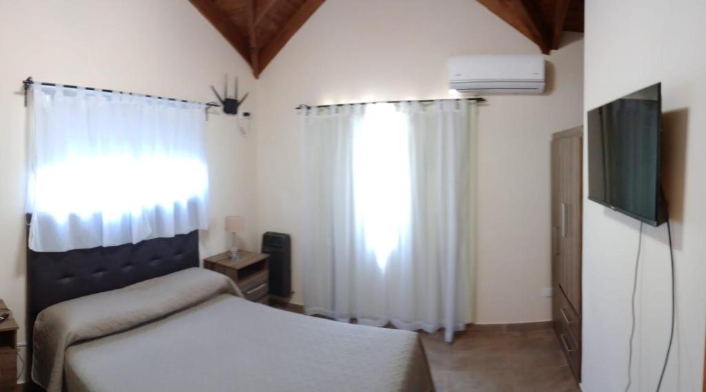 En eller flere senge i et værelse på Complejo Cerro Negro VGB