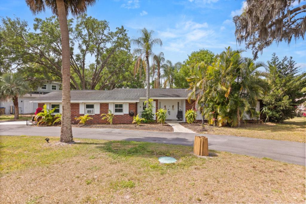 a house with palm trees in front of a street at Luxury Home, Workspace, Movie Room and BBQ in Kissimmee