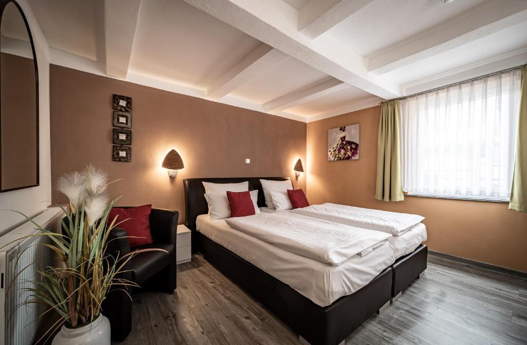 Postel nebo postele na pokoji v ubytování Le petit Palais - Hotel/Pension