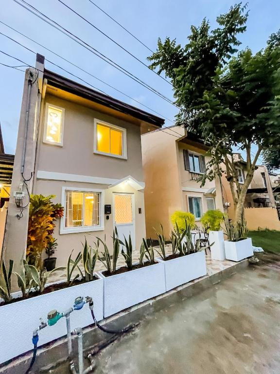 a house with plants in front of it at Isha's Place Self Check-In 2BR Netflix WiFi Camella Homes Villakananga in Butuan