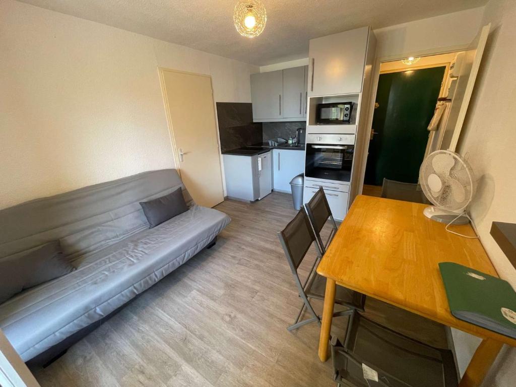 un salon avec un canapé et une table dans l'établissement Appartement climatisé avec 1 chambre à deux pas de la plage des Sablettes, à La Seyne-sur-Mer