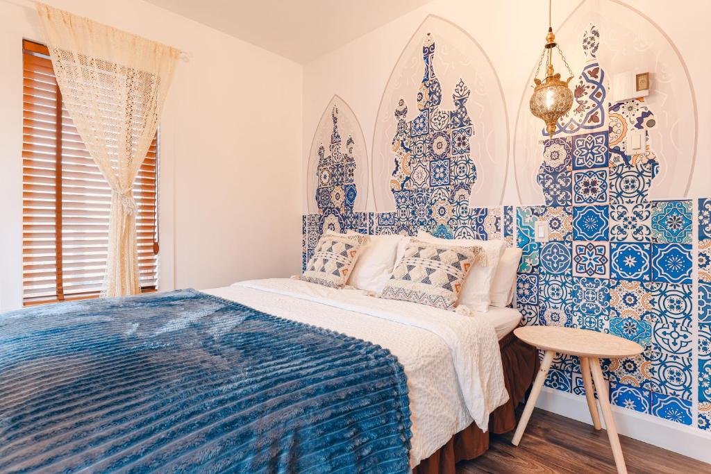 a bedroom with a bed with blue and white tiles at Luxury Boho-Inspired APT in Montreal in Montréal