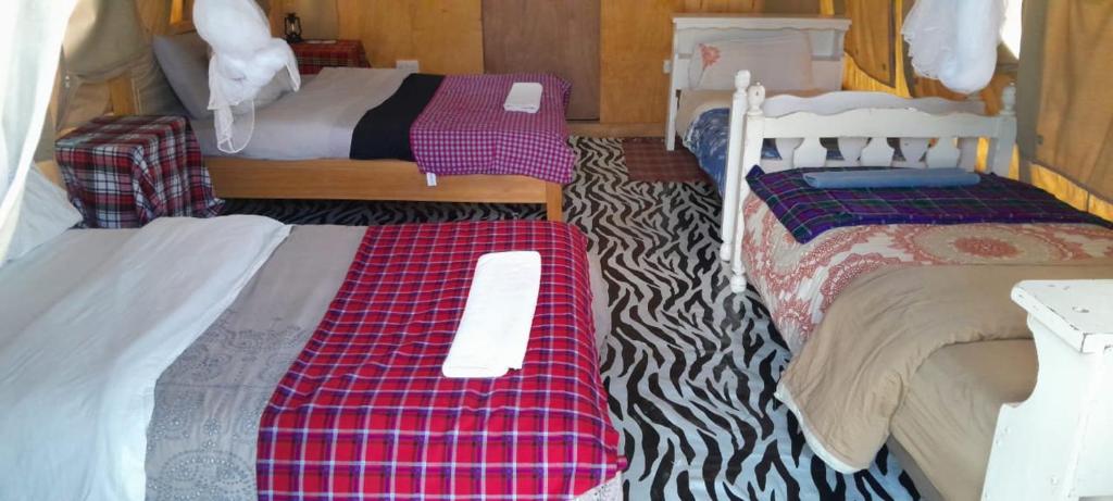 Postel nebo postele na pokoji v ubytování Mara Sidain safaris