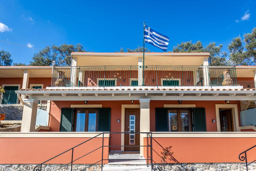 a building with an american flag on top of it at Villa Angelo in Paleokastritsa