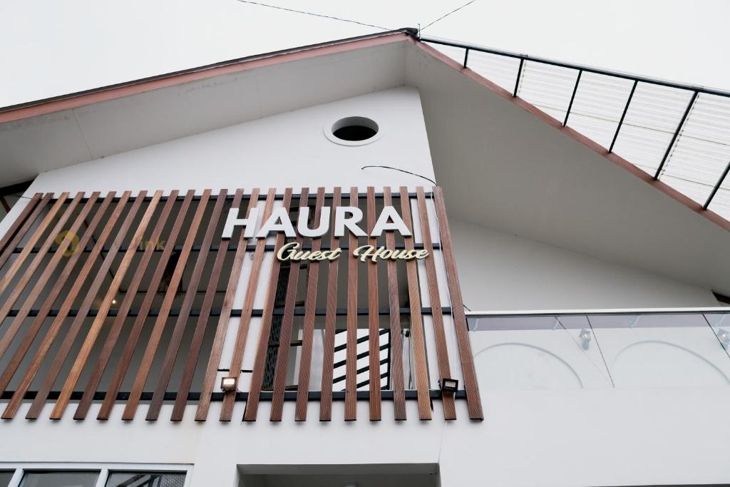 a staircase on a building with a sign on it at Haura By Travelink in Kejajar