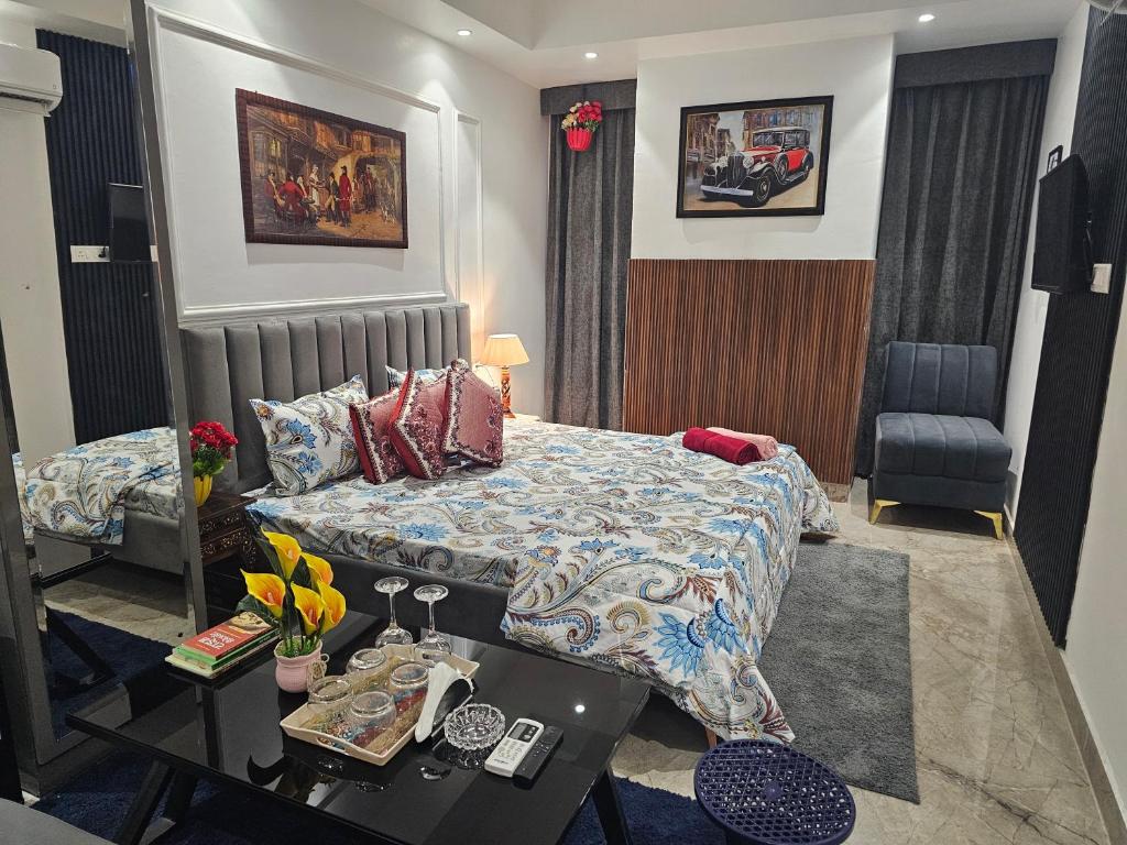 a hotel room with a bed and a table with a table at Ultra Luxury Cool Flat By Bliss Stay in Ghaggar