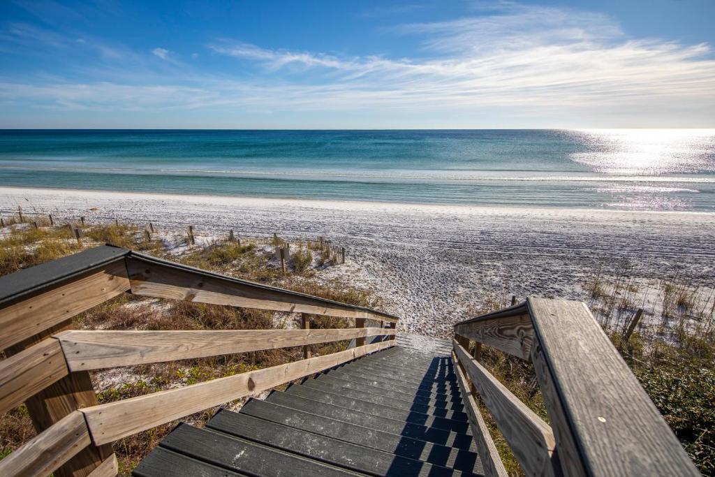 a boardwalk to the beach with the ocean in the background at Blue in Santa Rosa Beach